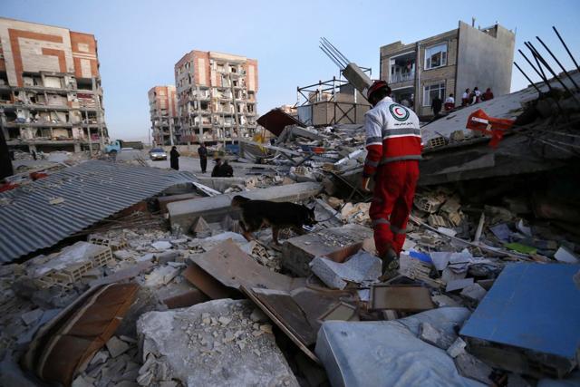In this photo provided by the Iranian Students News Agency, ISNA, a rescue worker searches debris for survivors with his sniffing dog after an earthquake at the city of Sarpol-e-Zahab in western Iran. (AP Photo) In this photo provided by the Iranian Students News Agency, ISNA, a rescue worker searches debris for survivors with his sniffing dog after an earthquake at the city of Sarpol-e-Zahab in western Iran. (AP Photo)