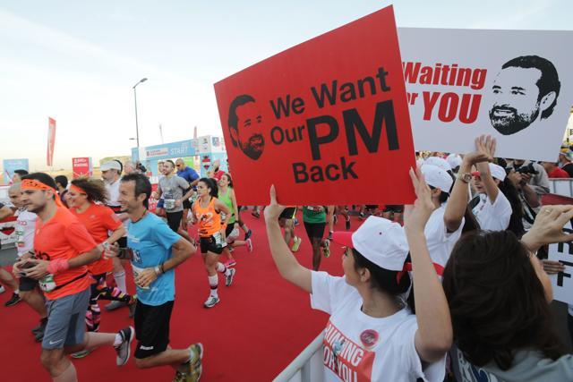 Supporters of Lebanon's former prime minister Saad Hariri hold up placards demanding his return from Saudi Arabia on the starting line of Beirut's annual marathon on November 12, 2017. (AFP) Supporters of Lebanon's former prime minister Saad Hariri hold up placards demanding his return from Saudi Arabia on the starting line of Beirut's annual marathon on November 12, 2017. (AFP)