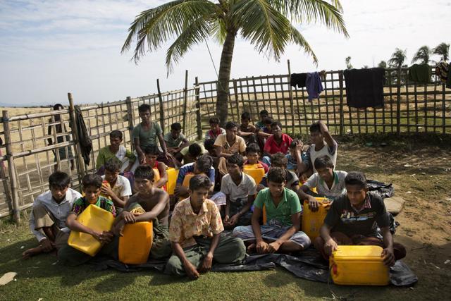 In this Nov. 4, 2017, photo, newly arrived Rohingya Muslims with yellow plastic drums they used to aid flotation while crossing the Naf river wait in Shah Porir Dwip to be transferred to a refugee camp in Cox's Bazar, Bangladesh. (AP) In this Nov. 4, 2017, photo, newly arrived Rohingya Muslims with yellow plastic drums they used to aid flotation while crossing the Naf river wait in Shah Porir Dwip to be transferred to a refugee camp in Cox's Bazar, Bangladesh. (AP)