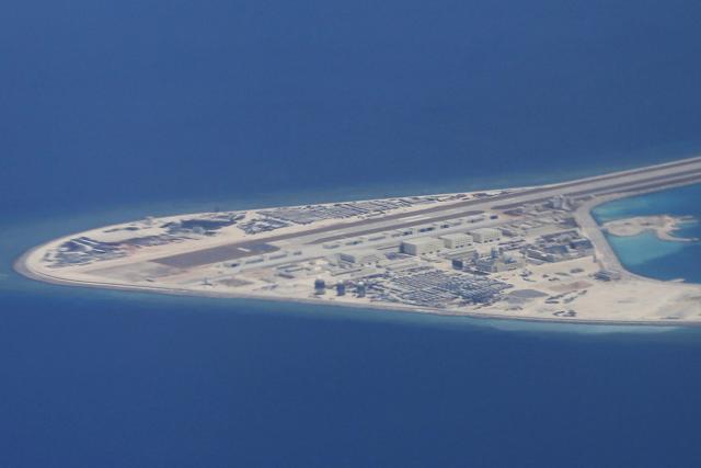 In this April 21, 2017, file photo, an airstrip, structures and buildings on China's man-made Subi Reef in the Spratly chain of islands in the South China Sea are seen from a Philippine Air Force C-130 transport plane of the Philippine Air Force. (AP) In this April 21, 2017, file photo, an airstrip, structures and buildings on China's man-made Subi Reef in the Spratly chain of islands in the South China Sea are seen from a Philippine Air Force C-130 transport plane of the Philippine Air Force. (AP)