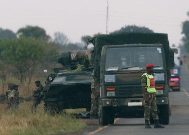 Soldiers stand beside military vehicles just outside Harare, Zimbabwe, on November 14, 2017. (Reuters) Soldiers stand beside military vehicles just outside Harare, Zimbabwe, on November 14, 2017. (Reuters)