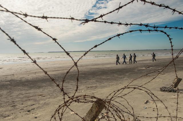 Myanmar border police patrol the beach near a makeshift camp in Rakhine state in Myanmar, where hundreds of Rohingya Muslims are waiting in makeshift camps before finding a way to cross over into Bangladesh. (AFP) Myanmar border police patrol the beach near a makeshift camp in Rakhine state in Myanmar, where hundreds of Rohingya Muslims are waiting in makeshift camps before finding a way to cross over into Bangladesh. (AFP)