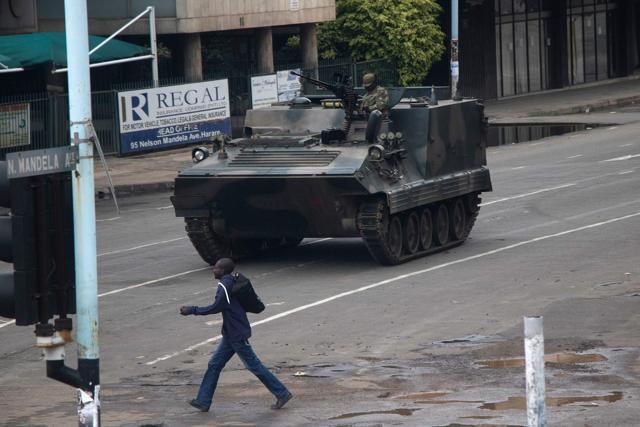 Zimbabwean soldiers stand by an intersection as they regulate civilian traffic in Harare on November 15. (AFP Photo) Zimbabwean soldiers stand by an intersection as they regulate civilian traffic in Harare on November 15. (AFP Photo)