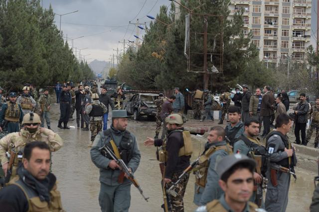 Afghan security personnel gather next to a vehicle which was used in a suicide bombing outside a wedding hall in Kabul on November 16, 2017. (AFP)
