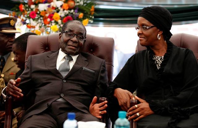 Zimbabwe President Robert Mugabe (left) speaks to his wife Grace at the funeral ceremony of his sister, Bridget in the village of Zvimba. (Reuters File Photo) Zimbabwe President Robert Mugabe (left) speaks to his wife Grace at the funeral ceremony of his sister, Bridget in the village of Zvimba. (Reuters File Photo)
