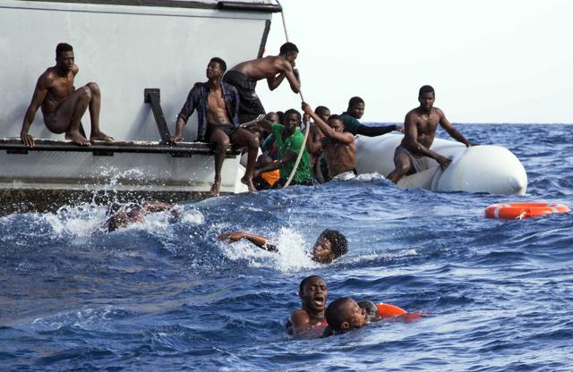 In this photo provided by Sea-Watch, migrants from a sinking inflatable dinghy try to board a Libyan coast guard ship during a rescue operation at sea in international waters off the coast of Libya. (AP File Photo) In this photo provided by Sea-Watch, migrants from a sinking inflatable dinghy try to board a Libyan coast guard ship during a rescue operation at sea in international waters off the coast of Libya. (AP File Photo)