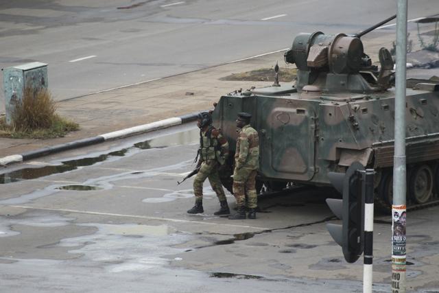 A military tank is seen with armed soldiers on the road leading to President Robert Mugabe's office in Harare, Zimbabwe. (AP File Photo) A military tank is seen with armed soldiers on the road leading to President Robert Mugabe's office in Harare, Zimbabwe. (AP File Photo)