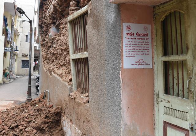 A Gujarati language warning notice related to a structurally damaged old heritage building in Ahmedabad. (AFP Photo) A Gujarati language warning notice related to a structurally damaged old heritage building in Ahmedabad. (AFP Photo)