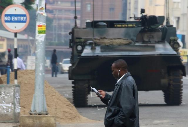 A man uses a mobile phone as he crosses the street in Harare, Zimbabwe November 17, 2017. (REUTERS) A man uses a mobile phone as he crosses the street in Harare, Zimbabwe November 17, 2017. (REUTERS)