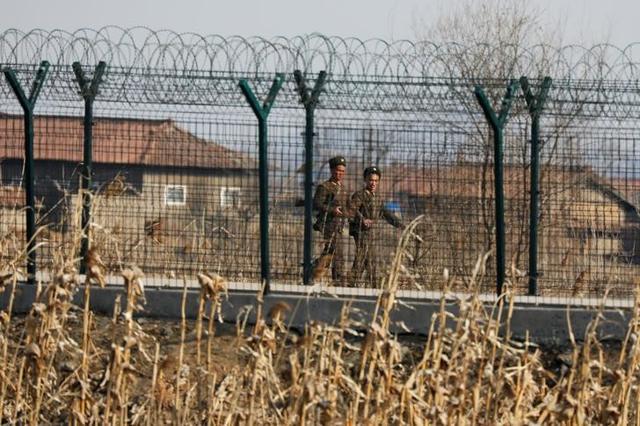 North Korean soldiers patrol behind a border fence near the North Korean town of Sinuiju. (Reuters File Photo) North Korean soldiers patrol behind a border fence near the North Korean town of Sinuiju. (Reuters File Photo)