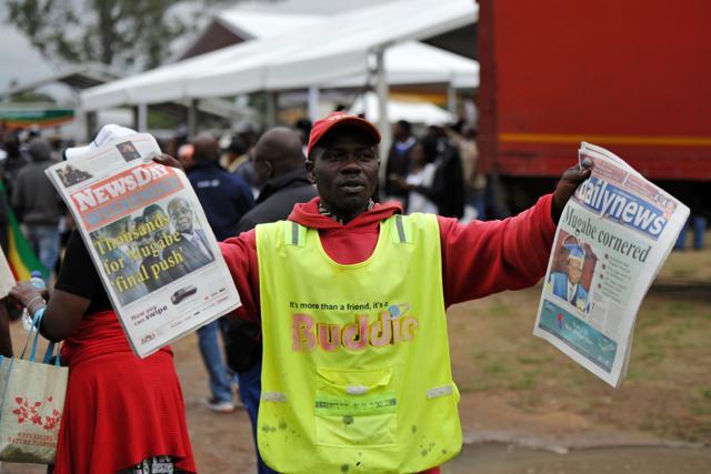 A man sells newspapers as people take part in a demonstration demanding the resignation of Zimbabwe's president on November 18, 2017 in Harare. (AFP Photo) A man sells newspapers as people take part in a demonstration demanding the resignation of Zimbabwe's president on November 18, 2017 in Harare. (AFP Photo)