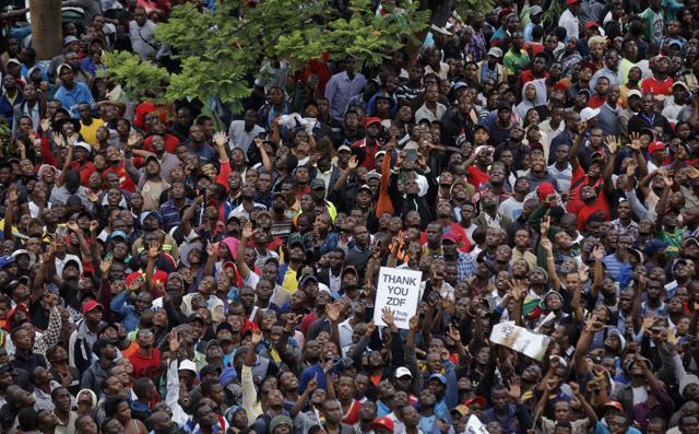 Protesters gather in front of an army cordon on the road leading to State House in Harare, Zimbabwe, on Saturday. (AP) Protesters gather in front of an army cordon on the road leading to State House in Harare, Zimbabwe, on Saturday. (AP)