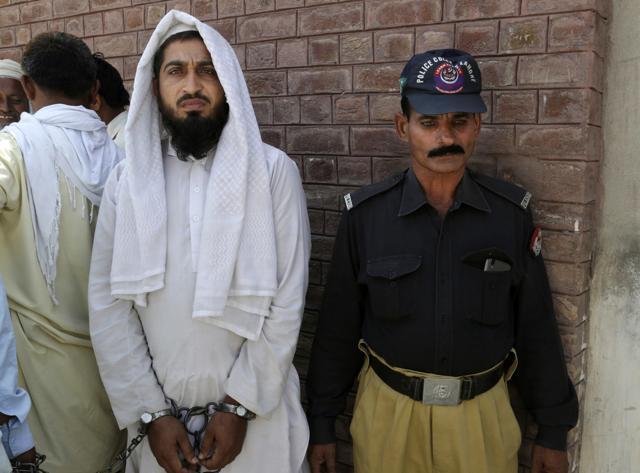 In this picture taken on May 4, 2017, a handcuffed Pakistani cleric who allegedly raped a child stands outside a court in Kehror Pakka, Pakistan. Sexual abuse in madrassas is widely known to happen in Pakistan, but culture, shame and fear all combine to make the reporting of these incidents by victims rare. (AP) In this picture taken on May 4, 2017, a handcuffed Pakistani cleric who allegedly raped a child stands outside a court in Kehror Pakka, Pakistan. Sexual abuse in madrassas is widely known to happen in Pakistan, but culture, shame and fear all combine to make the reporting of these incidents by victims rare. (AP)