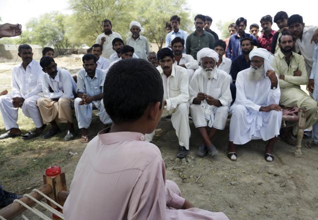 In this picture taken on August 18, 2017, a Pakistani boy who was allegedly raped by a mullah sits before villagers in Vehari, Pakistan. (AP) In this picture taken on August 18, 2017, a Pakistani boy who was allegedly raped by a mullah sits before villagers in Vehari, Pakistan. (AP)