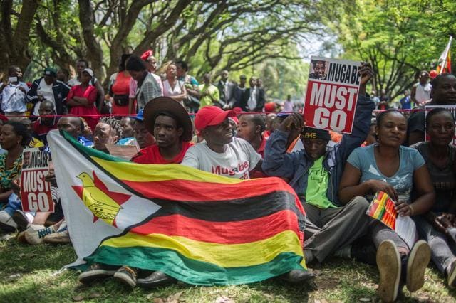 Zimbabweans gather at Unity square opposite the Parliament to protest against Zimbabwean President Robert Mugabe in Harare. (AFP Photo) Zimbabweans gather at Unity square opposite the Parliament to protest against Zimbabwean President Robert Mugabe in Harare. (AFP Photo)