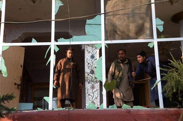 Afghan residents inspect damages on a building near the site of suicide attack in Jalalabad on November 23, 2017. (AFP)