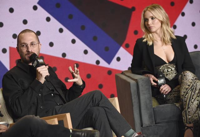 Director Darren Aronofsky, left, speaks as Jennifer Lawrence looks on during a press conference for mother!. (Evan Agostini/Invision/AP)