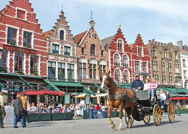 From the market square, tourists can trot off on horse-drawn carriages for a 30-minute tour of Bruges (iStock) From the market square, tourists can trot off on horse-drawn carriages for a 30-minute tour of Bruges (iStock)