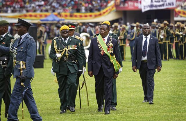 Emmerson Mnangagwa, center right, inspects the military parade after being sworn in as President at the presidential inauguration ceremony in the capital Harare, Zimbabwe Friday, Nov. 24, 2017. (AP) Emmerson Mnangagwa, center right, inspects the military parade after being sworn in as President at the presidential inauguration ceremony in the capital Harare, Zimbabwe Friday, Nov. 24, 2017. (AP)