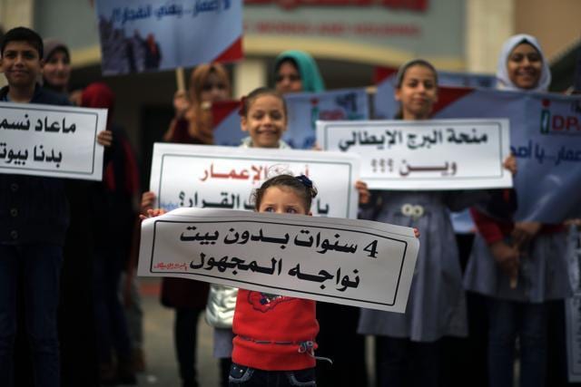 Palestinian children take part in a demonstration in Gaza City on November 23, 2017, calling for reconstruction of their homes, which were destroyed during the 50-day war between Israel and Hamas militants in the summer of 2014. (AFP) Palestinian children take part in a demonstration in Gaza City on November 23, 2017, calling for reconstruction of their homes, which were destroyed during the 50-day war between Israel and Hamas militants in the summer of 2014. (AFP)