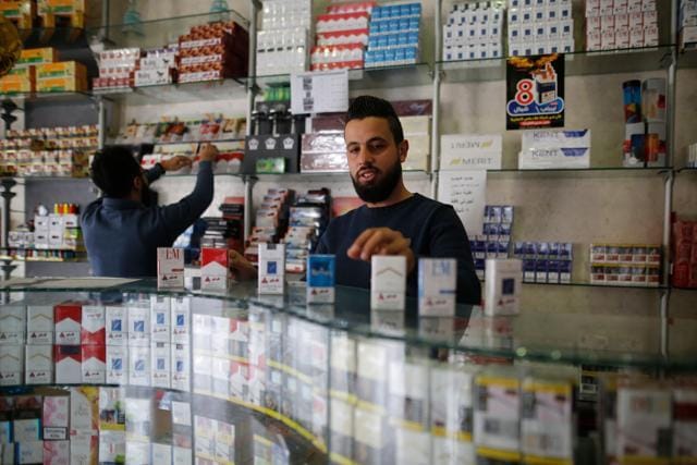Palestinian vendors sell cigarettes at a shope in Gaza City on November 13, 2017. (AFP) Palestinian vendors sell cigarettes at a shope in Gaza City on November 13, 2017. (AFP)