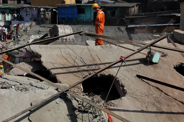 Residents suspect a woman is still trapped under the debris. (Praful Gangurde) Residents suspect a woman is still trapped under the debris. (Praful Gangurde)