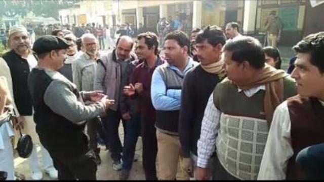 Nawazuddin Siddiqui waits in line to cast his vote.