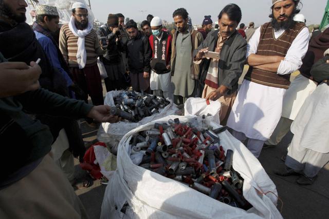Supporters of Tehreek-i-Labaik Ya Rasool Allah gather around a pile of empty tear gas canisters and rubble bullets fired by police during clashes in Islamabad. (AP Photo) Supporters of Tehreek-i-Labaik Ya Rasool Allah gather around a pile of empty tear gas canisters and rubble bullets fired by police during clashes in Islamabad. (AP Photo)