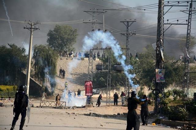 Police fire tear gas during clashes with protesters at Faizabad junction. (Reuters) Police fire tear gas during clashes with protesters at Faizabad junction. (Reuters)