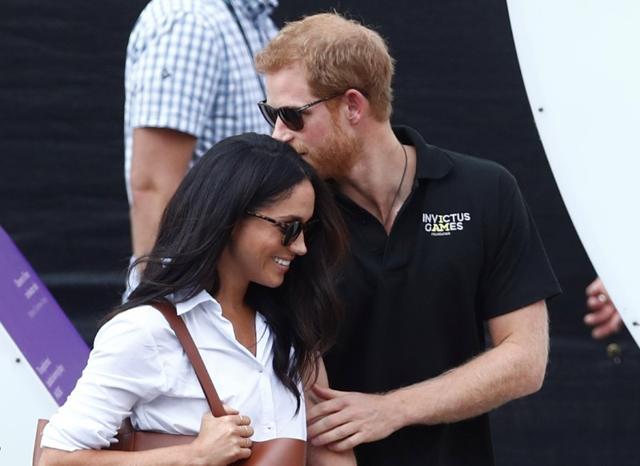 Britain's Prince Harry (R) arrives with girlfriend Meghan Markle at the wheelchair tennis event during the Invictus Games in Toronto, Ontario, Canada September 25 Britain's Prince Harry (R) arrives with girlfriend Meghan Markle at the wheelchair tennis event during the Invictus Games in Toronto, Ontario, Canada September 25
