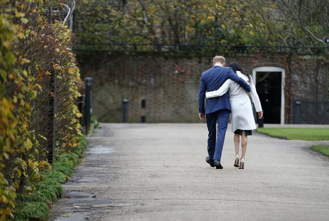 Britain's Prince Harry and Meghan Markle walk away after posing for the media in the grounds of Kensington Palace in London. (AP) Britain's Prince Harry and Meghan Markle walk away after posing for the media in the grounds of Kensington Palace in London. (AP)