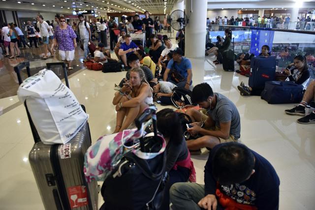 Passengers gather at the Gusti Ngurah Rai International airport in Denpasar, Bali. (AFP) Passengers gather at the Gusti Ngurah Rai International airport in Denpasar, Bali. (AFP)