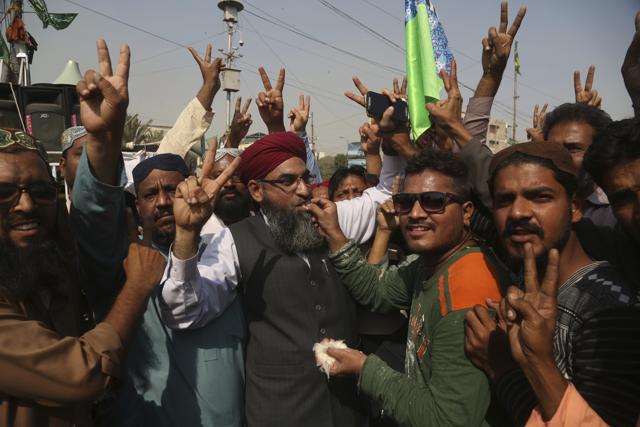 Supporters of the radical religious party Tehreek-e-Labbaik Pakistan celebrate after the country's law minister Zahid Hamid's resignation during a sit-in protest in Karachi on November 27, 2017. (AP) Supporters of the radical religious party Tehreek-e-Labbaik Pakistan celebrate after the country's law minister Zahid Hamid's resignation during a sit-in protest in Karachi on November 27, 2017. (AP)