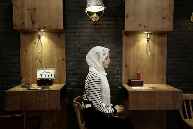 A customer waits for her food at the prison-themed restaurant. (AP) A customer waits for her food at the prison-themed restaurant. (AP)