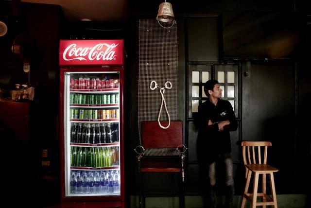 A waiter waits for his next order. (AP) A waiter waits for his next order. (AP)