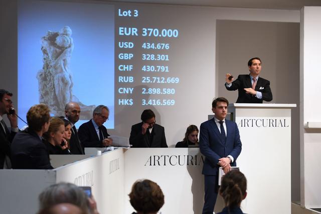 Auctioneer Matthieu Fournier (R) calls the sale at 370,000 euros for preliminary version number two of sculpture "L'Abandon." (AFP) Auctioneer Matthieu Fournier (R) calls the sale at 370,000 euros for preliminary version number two of sculpture "L'Abandon." (AFP)