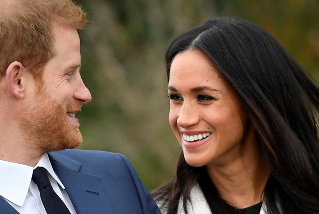 Britain's Prince Harry poses with Meghan Markle in the Sunken Garden of Kensington Palace, London, Britain. (REUTERS)