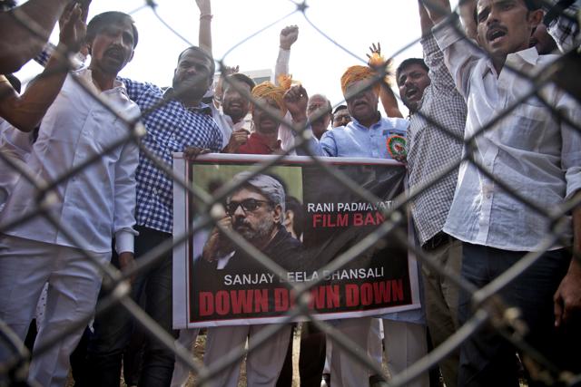 Members of India's Rajput community hold a poster of film director Sanjay Leela Bhansali and shout slogans as they protest against the release of Bollywood film Padmavati in Hyderabad, India. (AP) Members of India's Rajput community hold a poster of film director Sanjay Leela Bhansali and shout slogans as they protest against the release of Bollywood film Padmavati in Hyderabad, India. (AP)