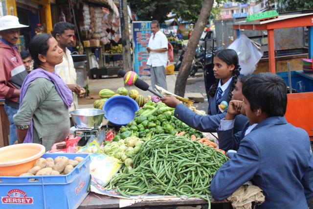 Reorters in Bengaluru interview vegetable vendors about rising prices.