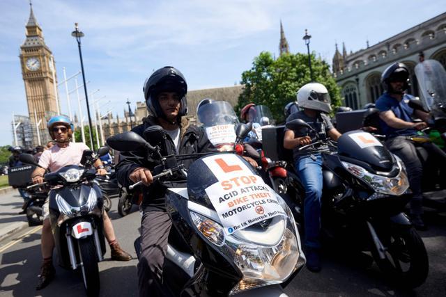 Motorcycle delivery drivers and motorcyclists taking part in a demonstration in Parliament Square in central London on July 18, 2017, following a spate of acid attacks on July 13. (AFP Photo)