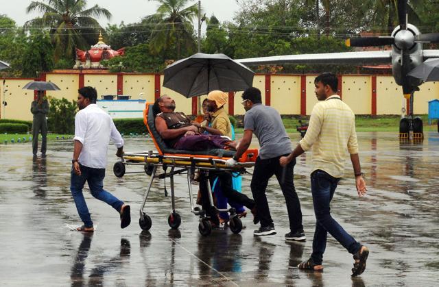 Officials carry a stranded fisherman, rescued by naval and air force helicopters from the Ockhi cyclone, at Thiruvananthpuram airport on Friday. (AFP) Officials carry a stranded fisherman, rescued by naval and air force helicopters from the Ockhi cyclone, at Thiruvananthpuram airport on Friday. (AFP)