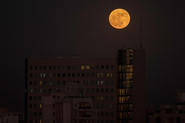 The supermoon rises over a building in the Israeli city of Netanya. (AFP) The supermoon rises over a building in the Israeli city of Netanya. (AFP)