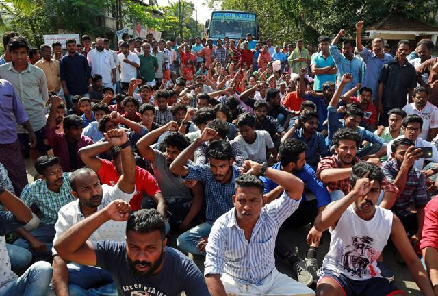 Residents block a road during a protest demanding that the government reconstruct damaged sea walls and provide rehabilitation to those staying near the seashore in Kerala on Sunday. (REUTERS) Residents block a road during a protest demanding that the government reconstruct damaged sea walls and provide rehabilitation to those staying near the seashore in Kerala on Sunday. (REUTERS)