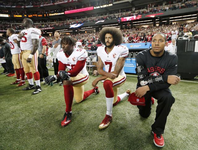 Colin Kaepernick (second from right) kneels during the playing of the US national anthem before an NFL football game in Atlanta on December 18, 2016 (AP) Colin Kaepernick (second from right) kneels during the playing of the US national anthem before an NFL football game in Atlanta on December 18, 2016 (AP)