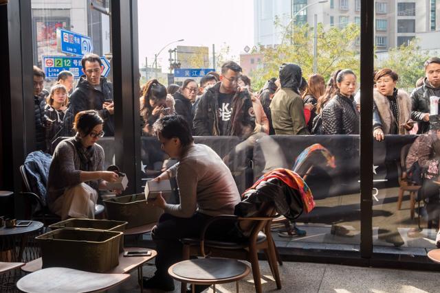 Visitors wait to enter the Starbucks Reserve Roastery outlet in Shanghai. (AFP) Visitors wait to enter the Starbucks Reserve Roastery outlet in Shanghai. (AFP)