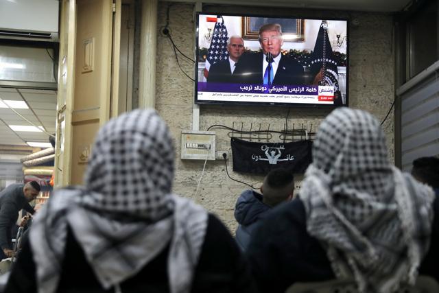 Palestinians watch a televised broadcast of US President Donald Trump delivering an address in Jerusalem's Old City. (Reuters Photo) Palestinians watch a televised broadcast of US President Donald Trump delivering an address in Jerusalem's Old City. (Reuters Photo)
