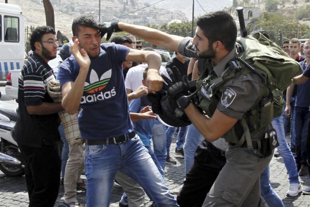 In this Friday, October 2, 2015, file photo, Israeli border policeman exchanges blows with a Palestinian man during a confrontation after Friday prayers outside the Old City in Jerusalem. (AP) In this Friday, October 2, 2015, file photo, Israeli border policeman exchanges blows with a Palestinian man during a confrontation after Friday prayers outside the Old City in Jerusalem. (AP)