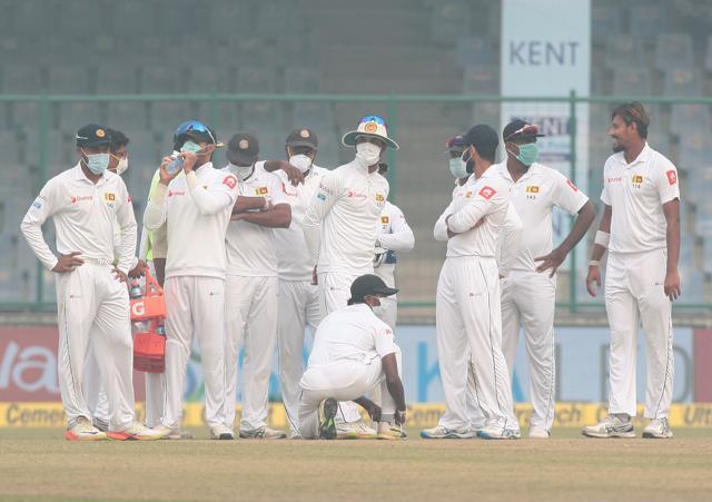 Sri Lanka players, wearing face masks due to pollution, celebrate the dismissal of India's Ajinkya Rahane during the third Test in Delhi. (REUTERS) Sri Lanka players, wearing face masks due to pollution, celebrate the dismissal of India's Ajinkya Rahane during the third Test in Delhi. (REUTERS)