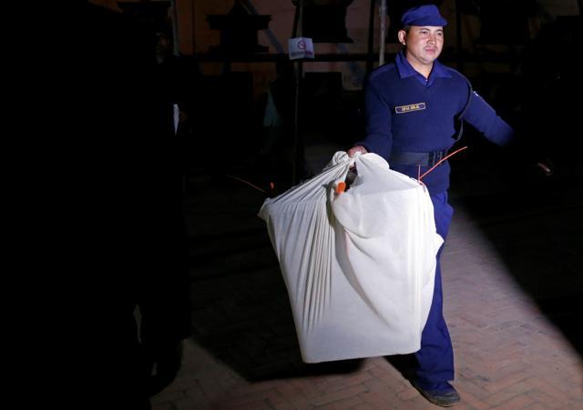 A police officer carries a sealed ballot box towards a vehicle after the completion of polling during the parliamentary and provincial elections in Kathmandu on December 7, 2017. (Reuters) A police officer carries a sealed ballot box towards a vehicle after the completion of polling during the parliamentary and provincial elections in Kathmandu on December 7, 2017. (Reuters)