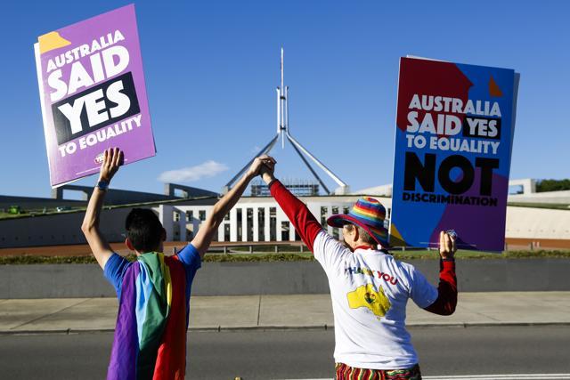 Equality ambassadors and volunteers from the The Equality Campaign gather in front of Parliament House in Canberra on December 7. (AFP Photo) Equality ambassadors and volunteers from the The Equality Campaign gather in front of Parliament House in Canberra on December 7. (AFP Photo)
